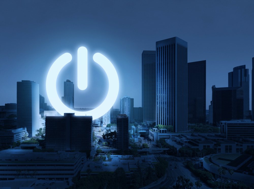 City skyline at dusk with a glowing power icon